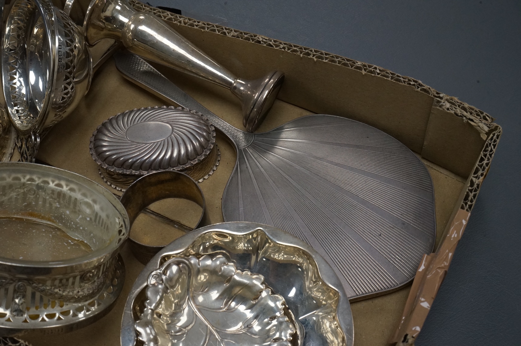 A group of small collectable silver including a late Victorian heart shaped trinket box, Chester, 1899, length 92mm (a.f.), a coaster, toast rack, spill vase, small trinket box, a pair of two handled dishes, napkin ring,